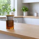 Tea infuser with Ukiyo branding on a wooden surface with a blurred kitchen background