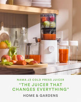 NAMA J3 cold press juicer with fruits and vegetables on a kitchen counter