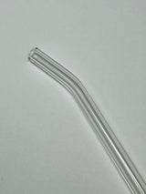 Clear glass straw on a light gray background